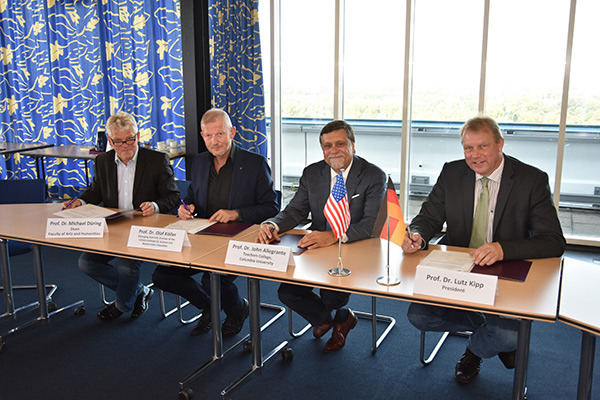 MAKING IT OFFICIAL Allegrante and Kipp sign the MOU along with University of Kiel Professor Michael Düring, and IPN Director and Professor Olaf Köller. (Jan Winters, CAU)