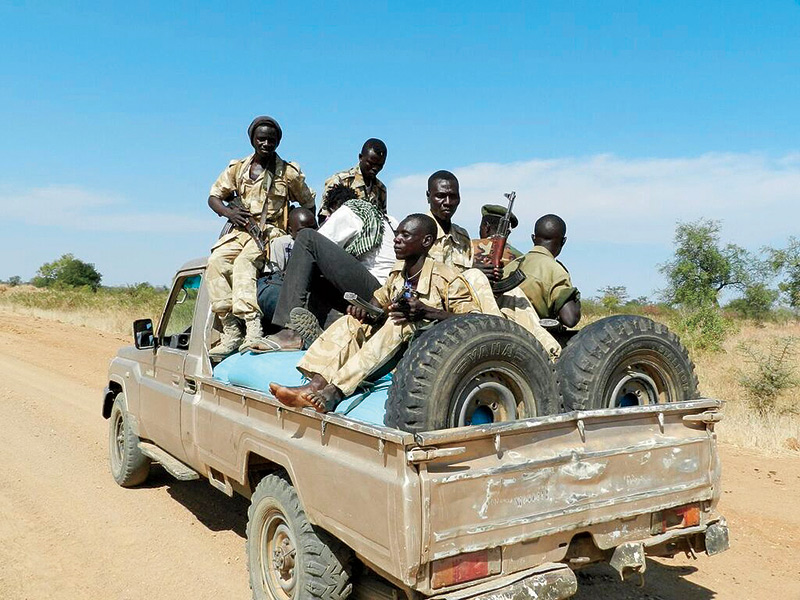 Soldiers in South Sudan sitting on a truck bed